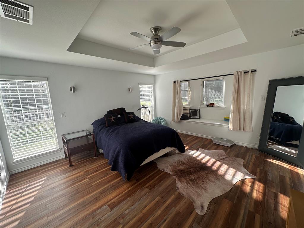 2387 Forehand Road Trinidad, TX 75163 - Photo 17 of 25 a bedroom with a bed window and a ceiling fan