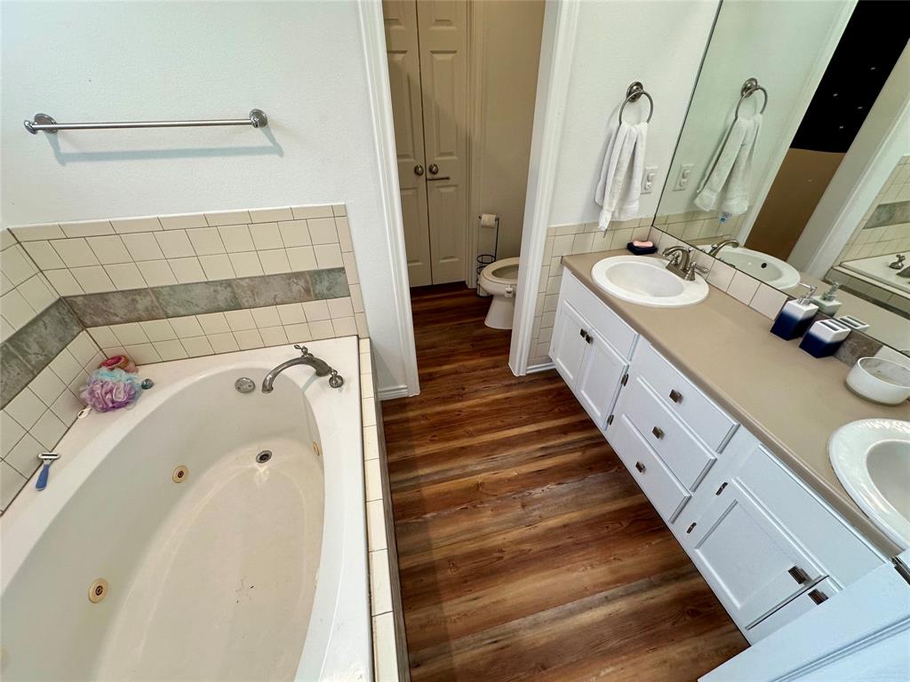 2387 Forehand Road Trinidad, TX 75163 - Photo 20 of 25 a bathroom with a double vanity sink and a mirror