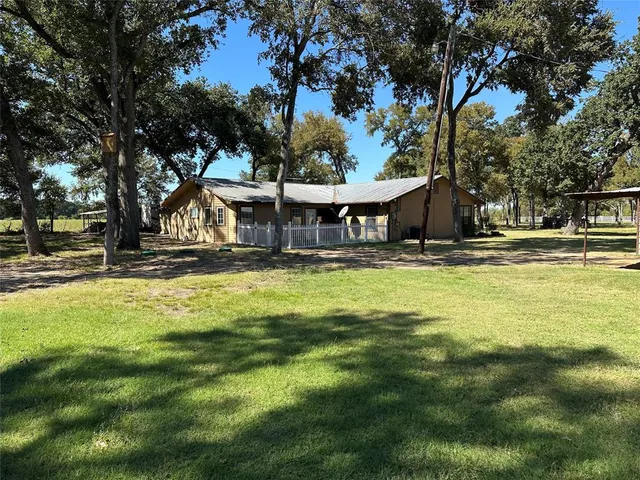 a swimming pool with outdoor seating and yard
