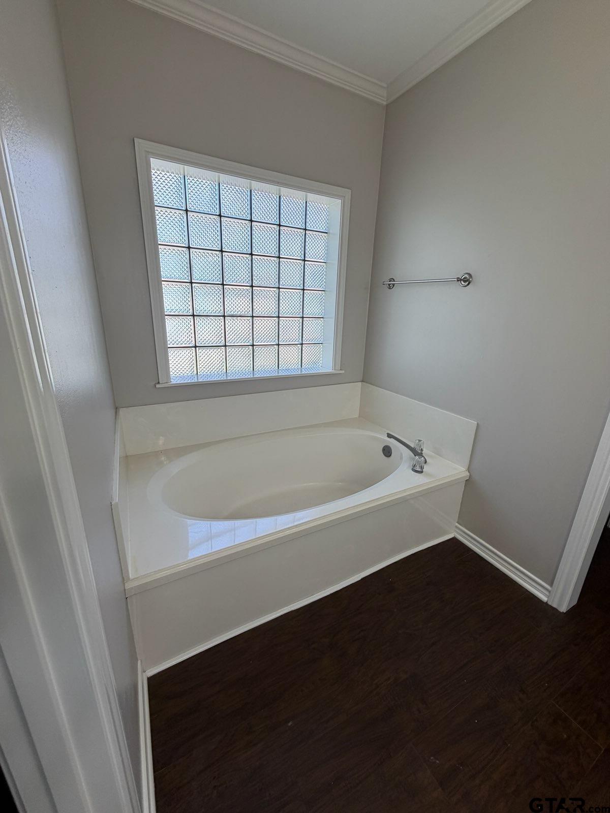 3204 Pebblebrook Circle Tyler, TX 75707 - Photo 14 of 18 a white bath tub sitting in a bathroom