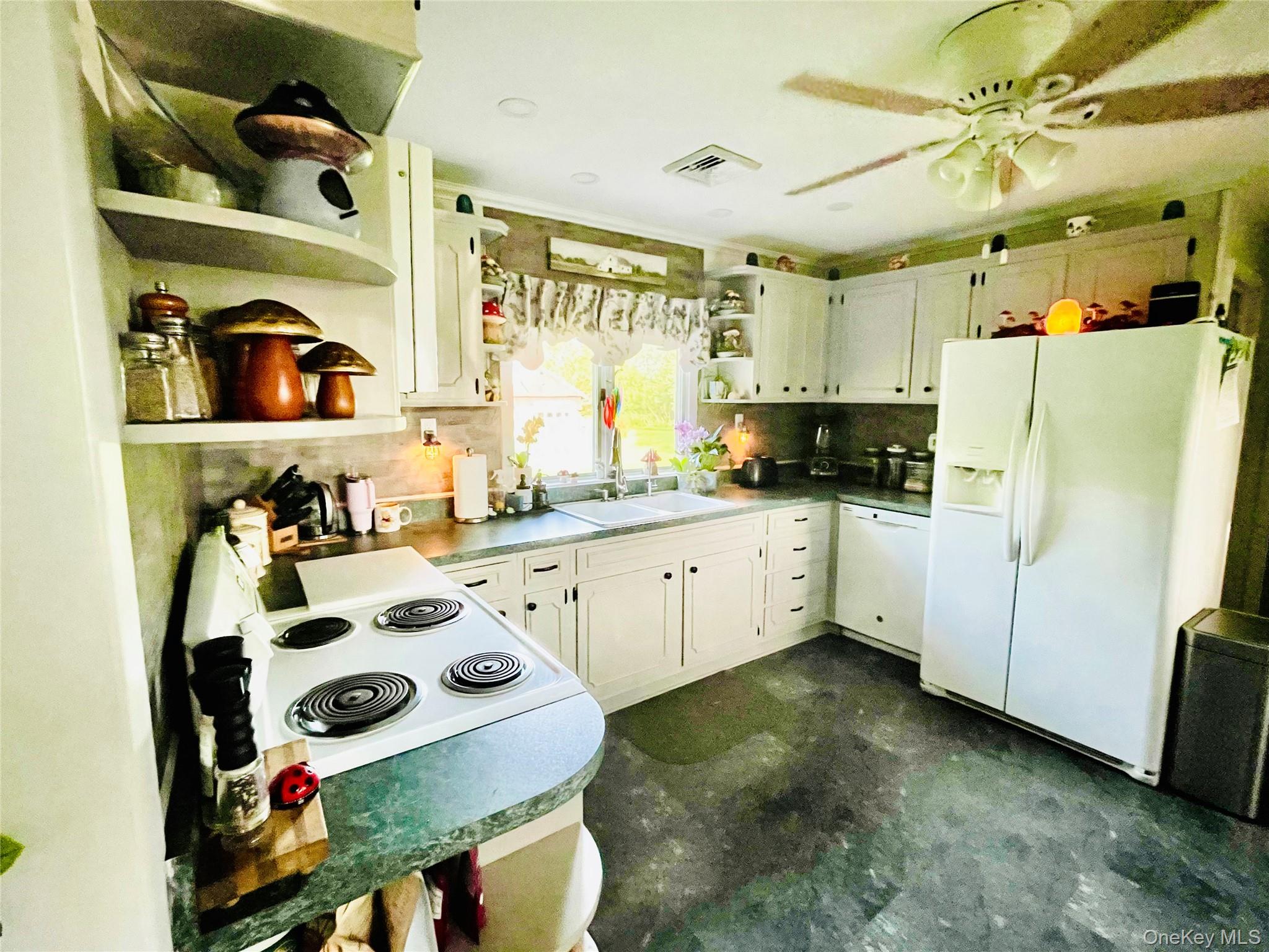 137 Cross Road Goshen, NY 10924 - Photo 8 of 50 a kitchen with a sink a stove and white cabinets