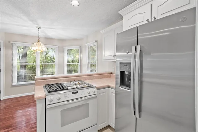 a kitchen with a stove and a refrigerator