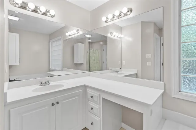 a bathroom with a sink double vanity and a mirror
