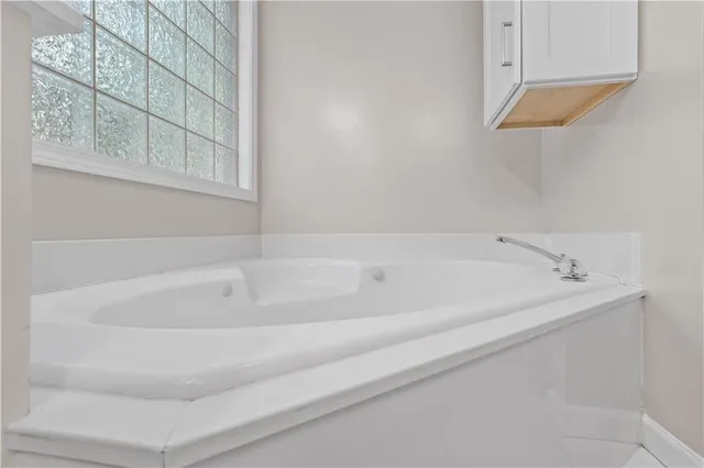 a white bath tub sitting next to a window