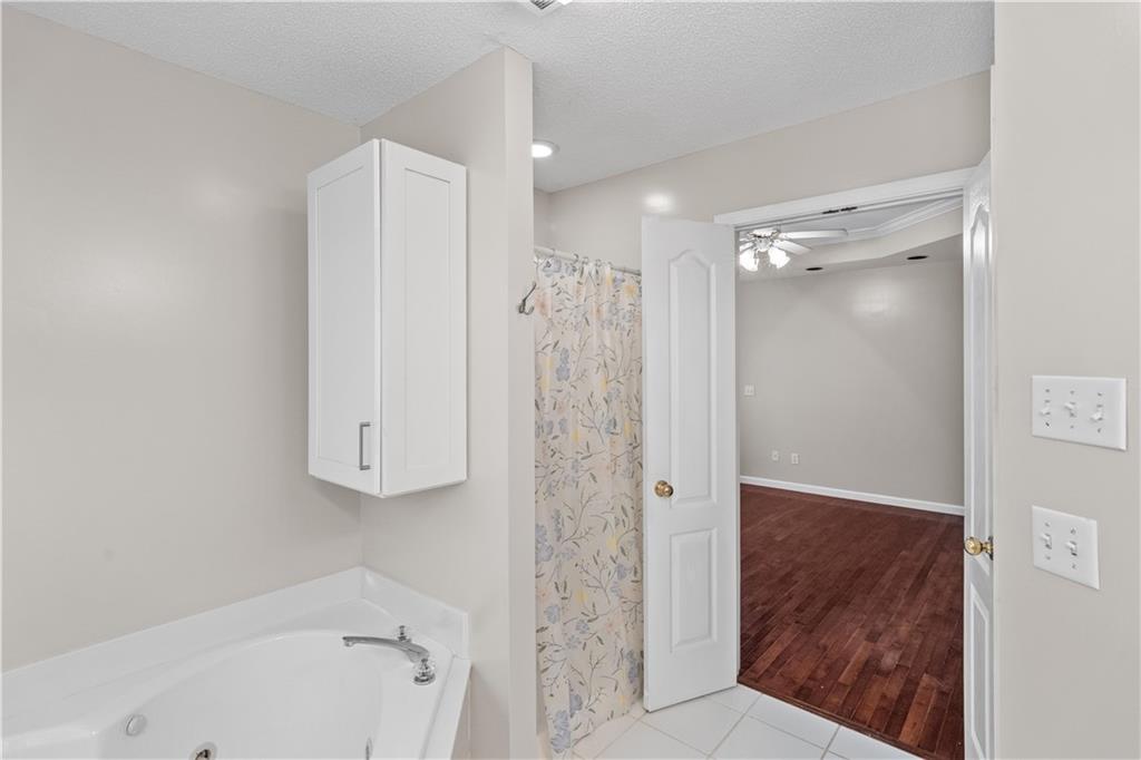 137 Hunters Trail Calhoun, GA 30701 - Photo 18 of 33 a bathroom with a shower and a tub