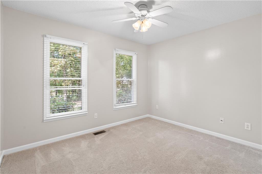 137 Hunters Trail Calhoun, GA 30701 - Photo 20 of 33 an empty room with a window and a fan