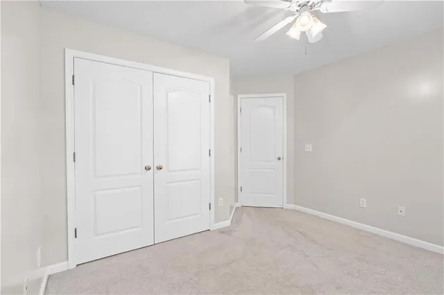 an empty room with a chandelier fan