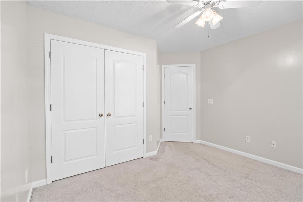 137 Hunters Trail Calhoun, GA 30701 - Photo 21 of 33 an empty room with a chandelier fan