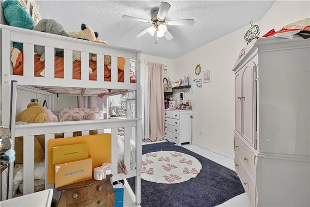 a living room with furniture and baby crib