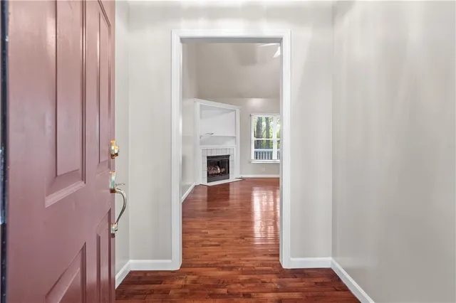 a view of a livingroom with wooden floor and a ceiling fan