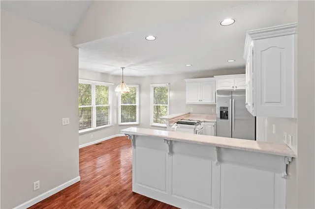 a large white kitchen with a large window