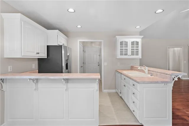 a kitchen with a sink stove and refrigerator