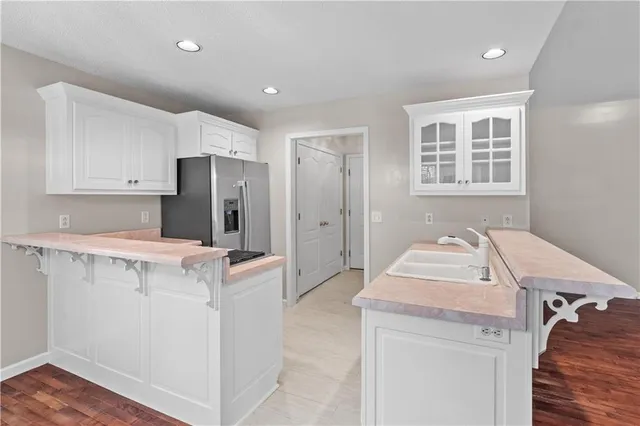 a kitchen with a refrigerator and sink