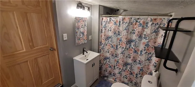 a bathroom with a shower curtain and a sink
