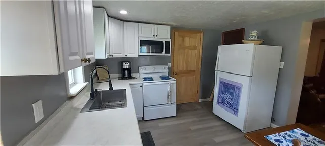 a kitchen with a refrigerator sink and stove