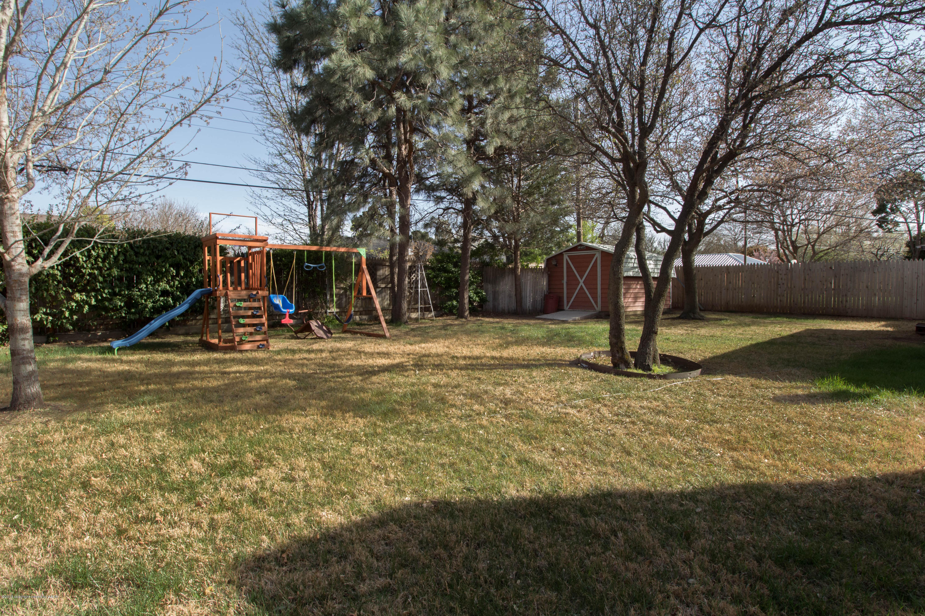 6111 Elmhurst Road Amarillo, TX 79106 - Photo 22 of 24 a view of a tree in front of a house