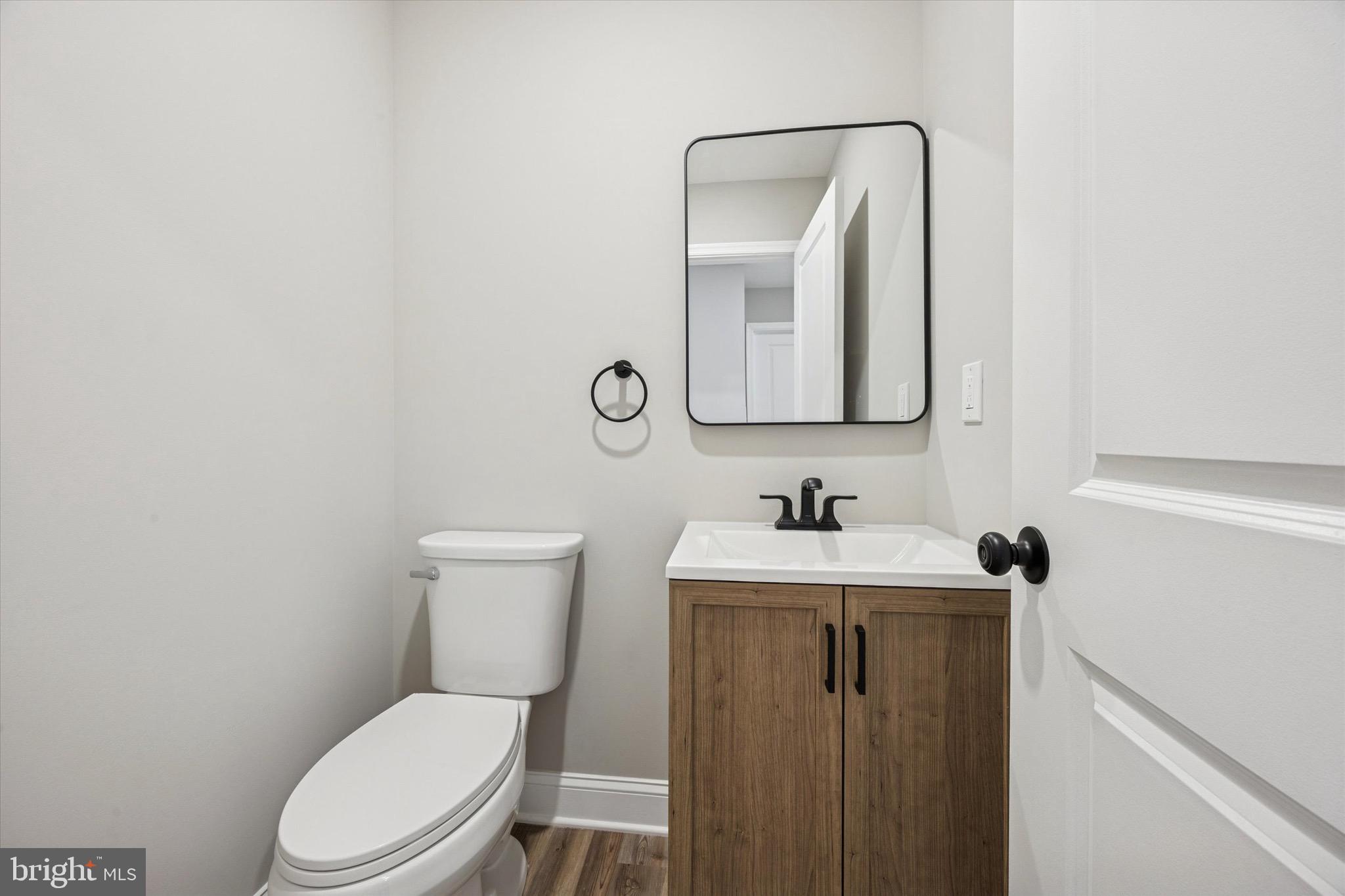 19 Rivanna Road New Castle, DE 19720 - Photo 9 of 26 a bathroom with a toilet a sink a vanity and mirror