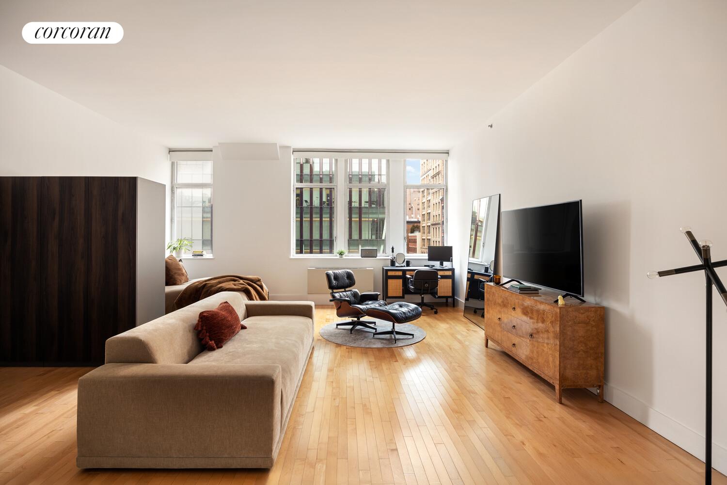 25 West Houston Street, Unit 5B Manhattan, NY 10012 - Photo 2 of 8 a living room with furniture and a flat screen tv