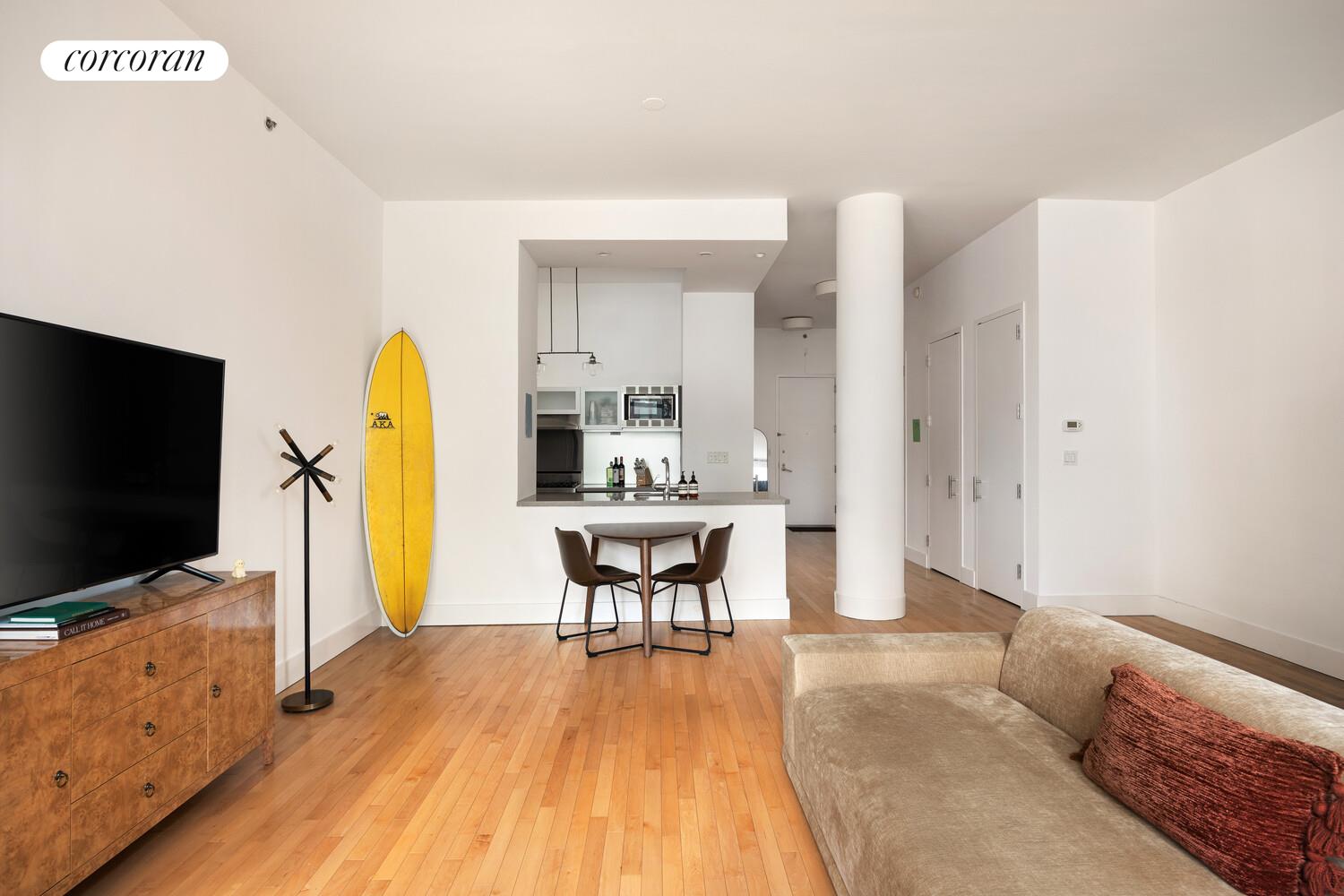 25 West Houston Street, Unit 5B Manhattan, NY 10012 - Photo 3 of 8 a living room with furniture and a flat screen tv