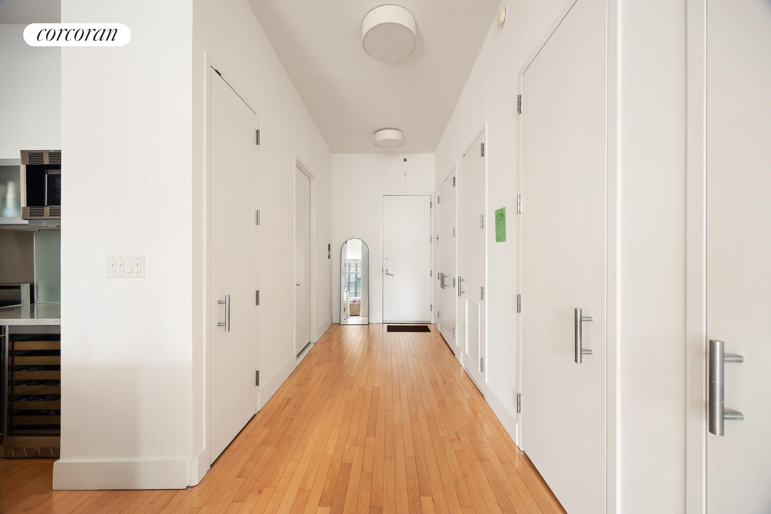 25 West Houston Street, Unit 5B Manhattan, NY 10012 - Photo 5 of 8 a view of a hallway with wooden floor