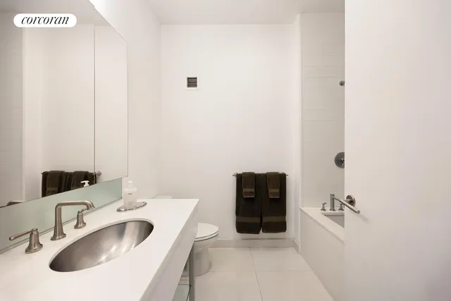 a kitchen with stainless steel appliances granite countertop a sink a stove a refrigerator cabinets and a dining table