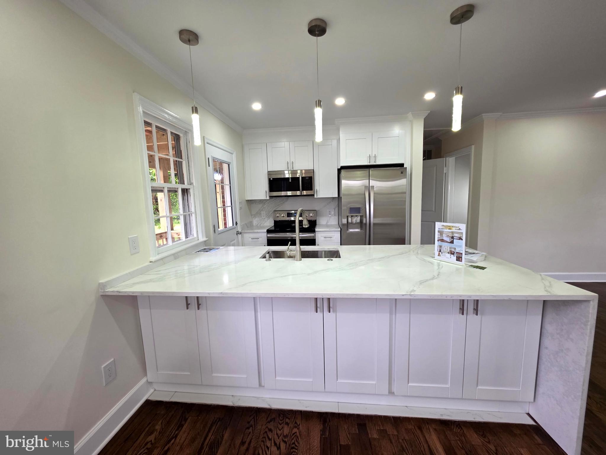 2206 Brinkley Road Fort Washington, MD 20744 - Photo 46 of 78 a kitchen with kitchen island granite countertop a sink a stove and cabinets
