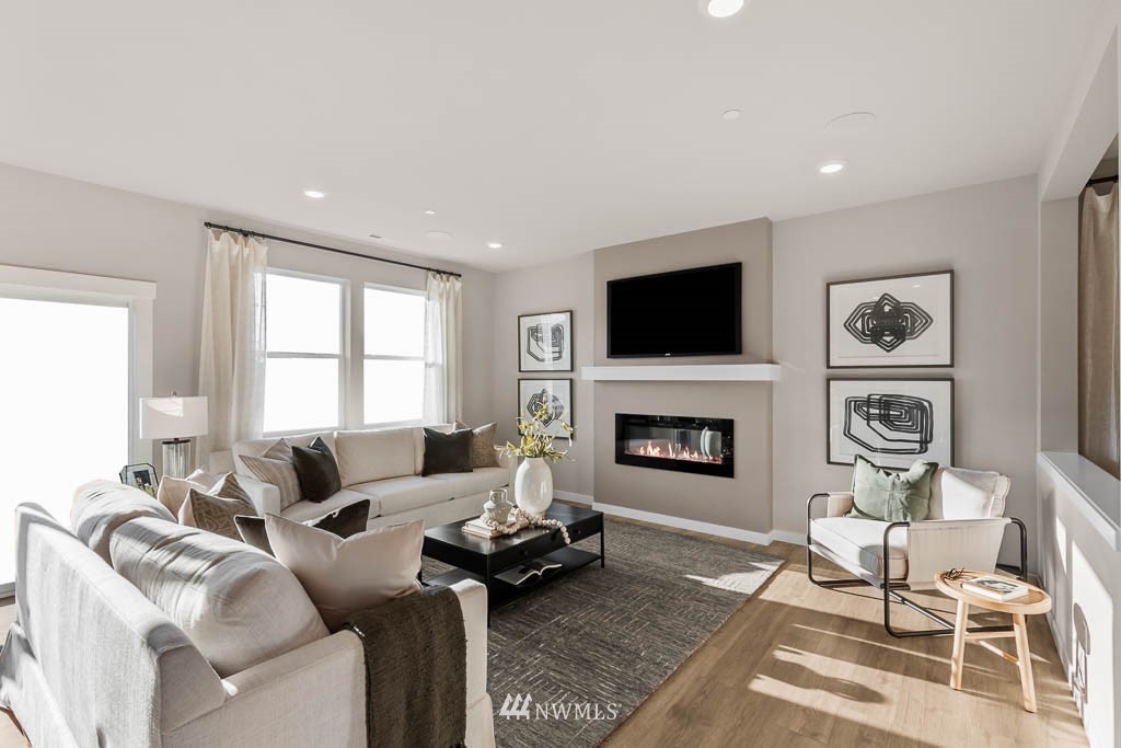 17 180th Place Southeast, Unit 42 Bothell, WA 98012 - Photo 16 of 38 a living room with furniture a fireplace and a flat screen tv
