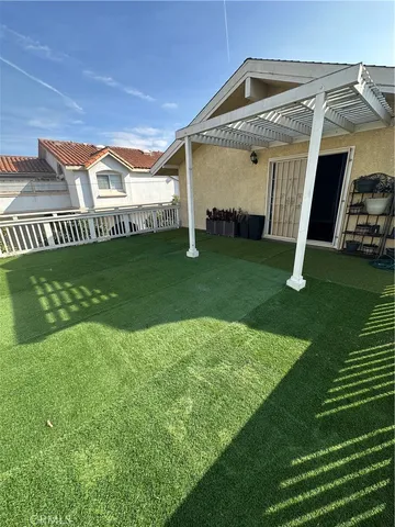a bathroom with a granite countertop double vanity sink a mirror and a bathtub