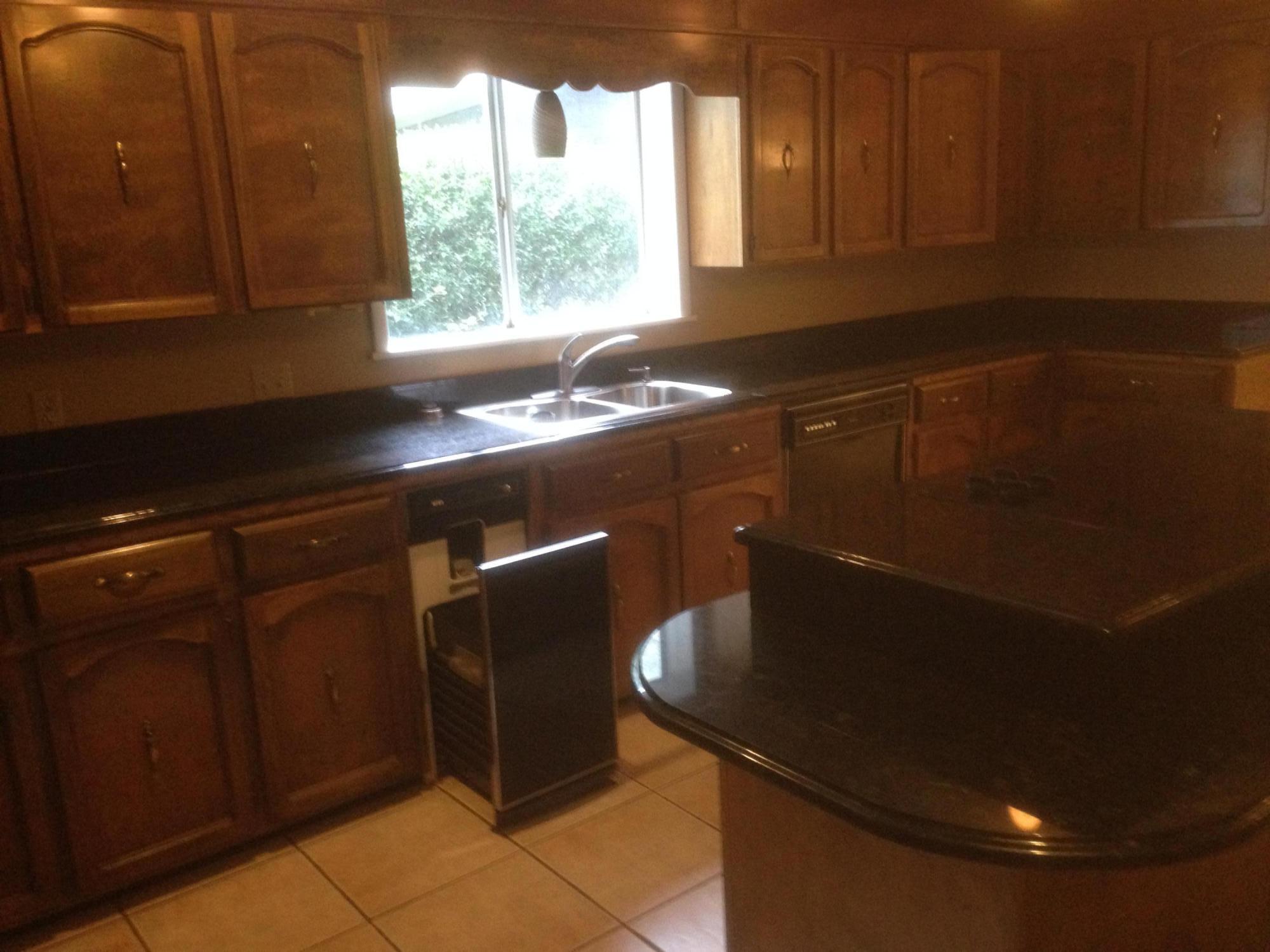 226 Country Club Road Shalimar, FL 32579 - Photo 14 of 35 a kitchen with a sink a window and cabinets