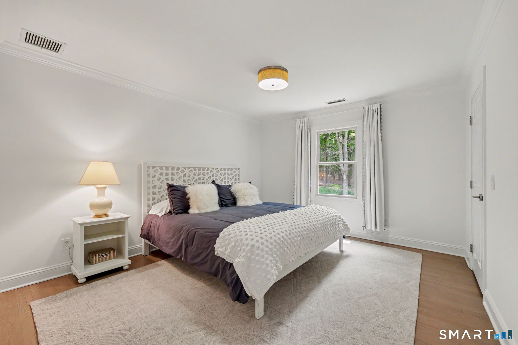 10 Side Hill Road Westport, CT 06880 - Photo 26 of 40 a spacious bedroom with a bed and a window