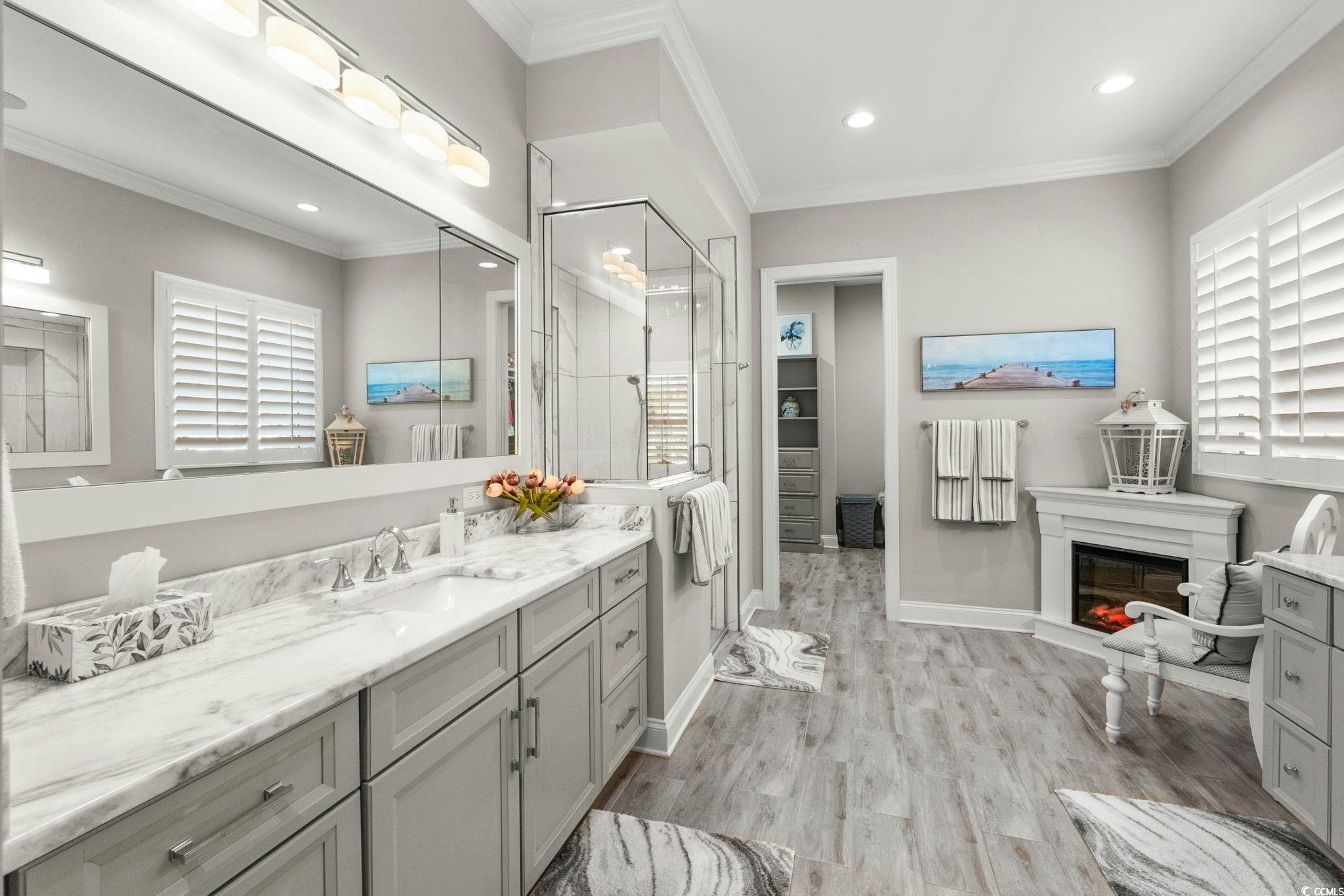 2225 Macerata Loop Myrtle Beach, SC 29579 - Photo 20 of 40 Full bath with crown molding, vanity, a walk in closet, light wood-style flooring, and a stall shower