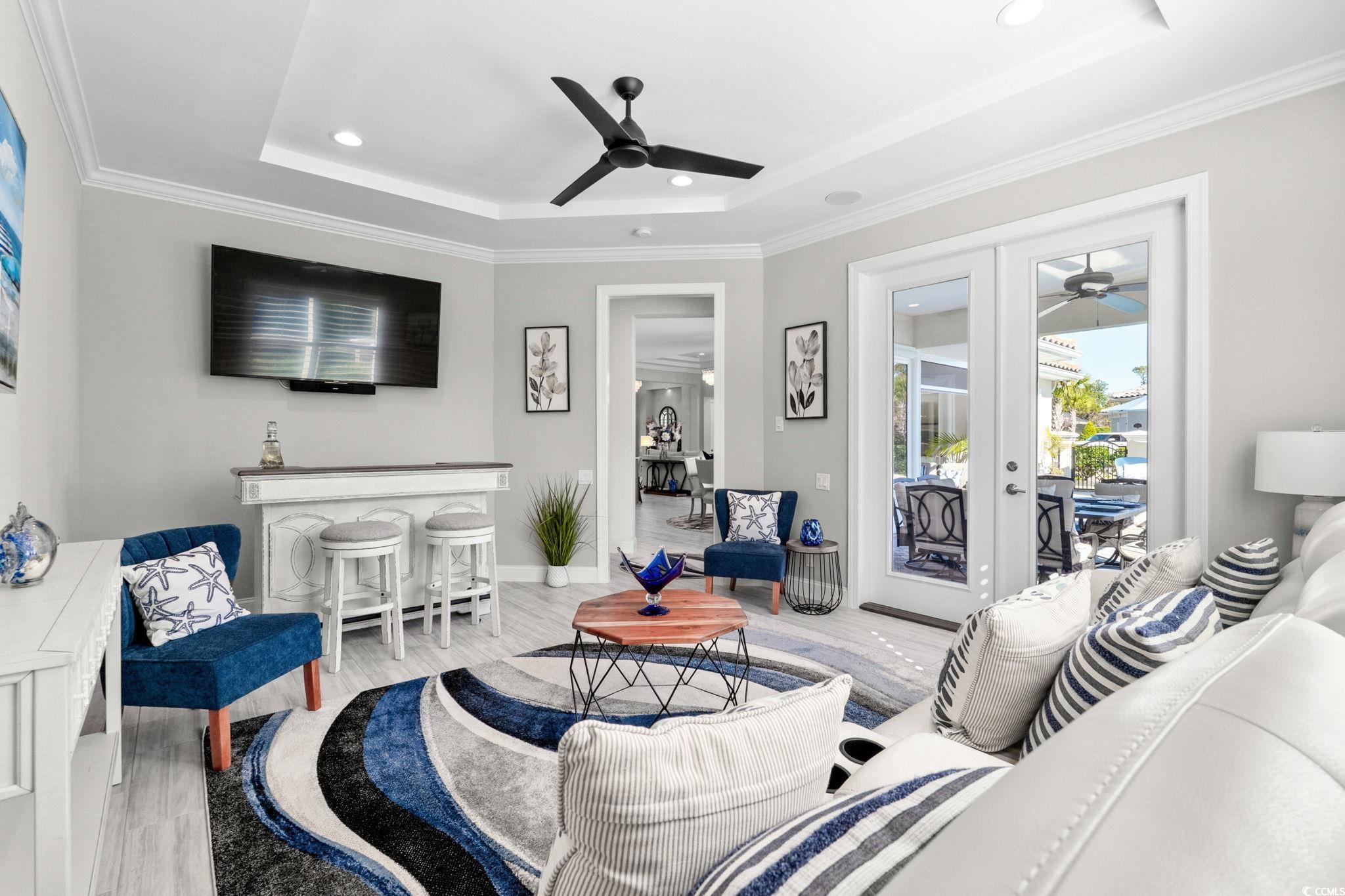 2225 Macerata Loop Myrtle Beach, SC 29579 - Photo 21 of 40 Living room with wood finished floors, a ceiling fan, ornamental molding, recessed lighting, and a tray ceiling