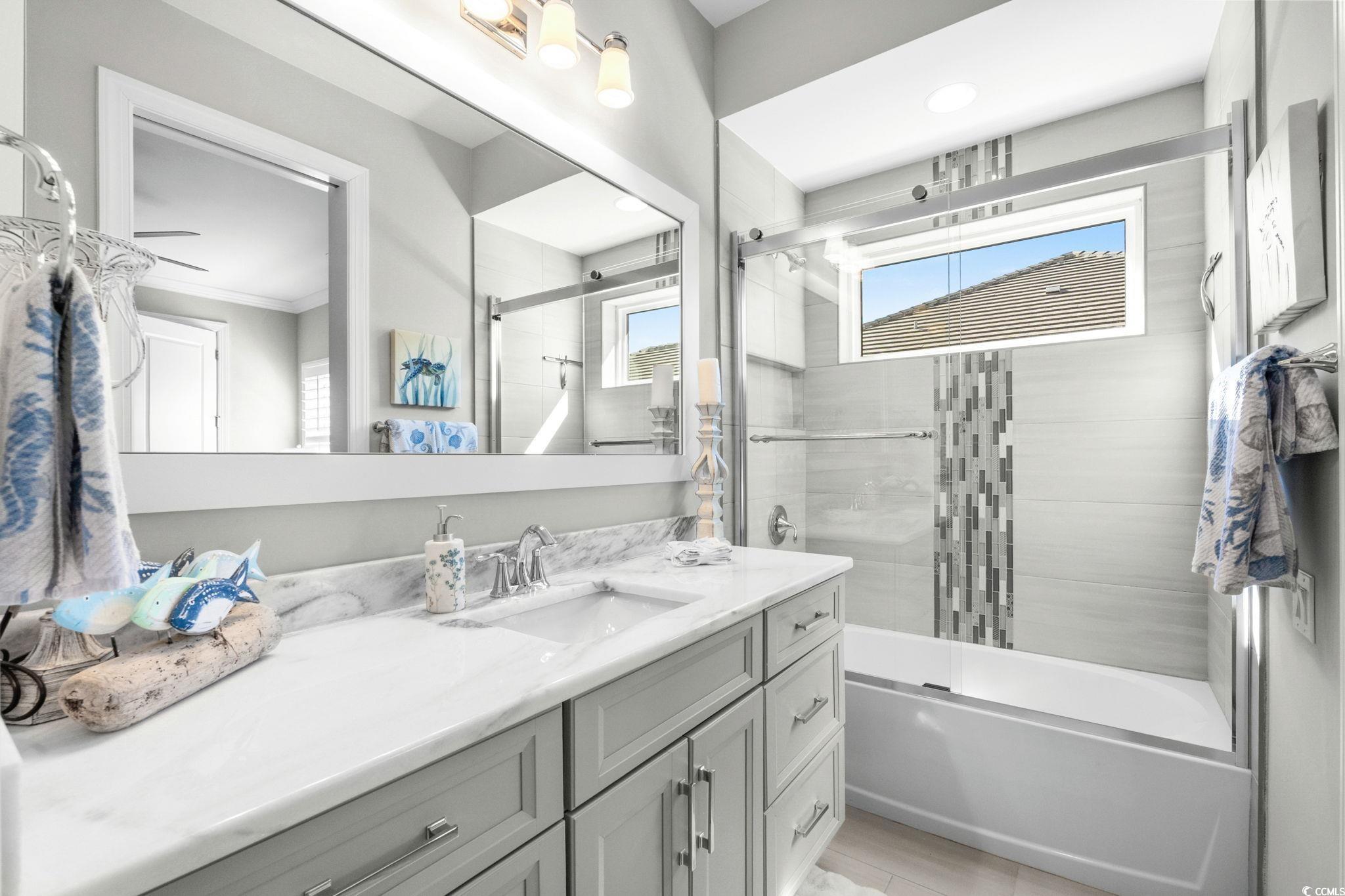 2225 Macerata Loop Myrtle Beach, SC 29579 - Photo 24 of 40 Bathroom featuring vanity, bath / shower combo with glass door, and crown molding