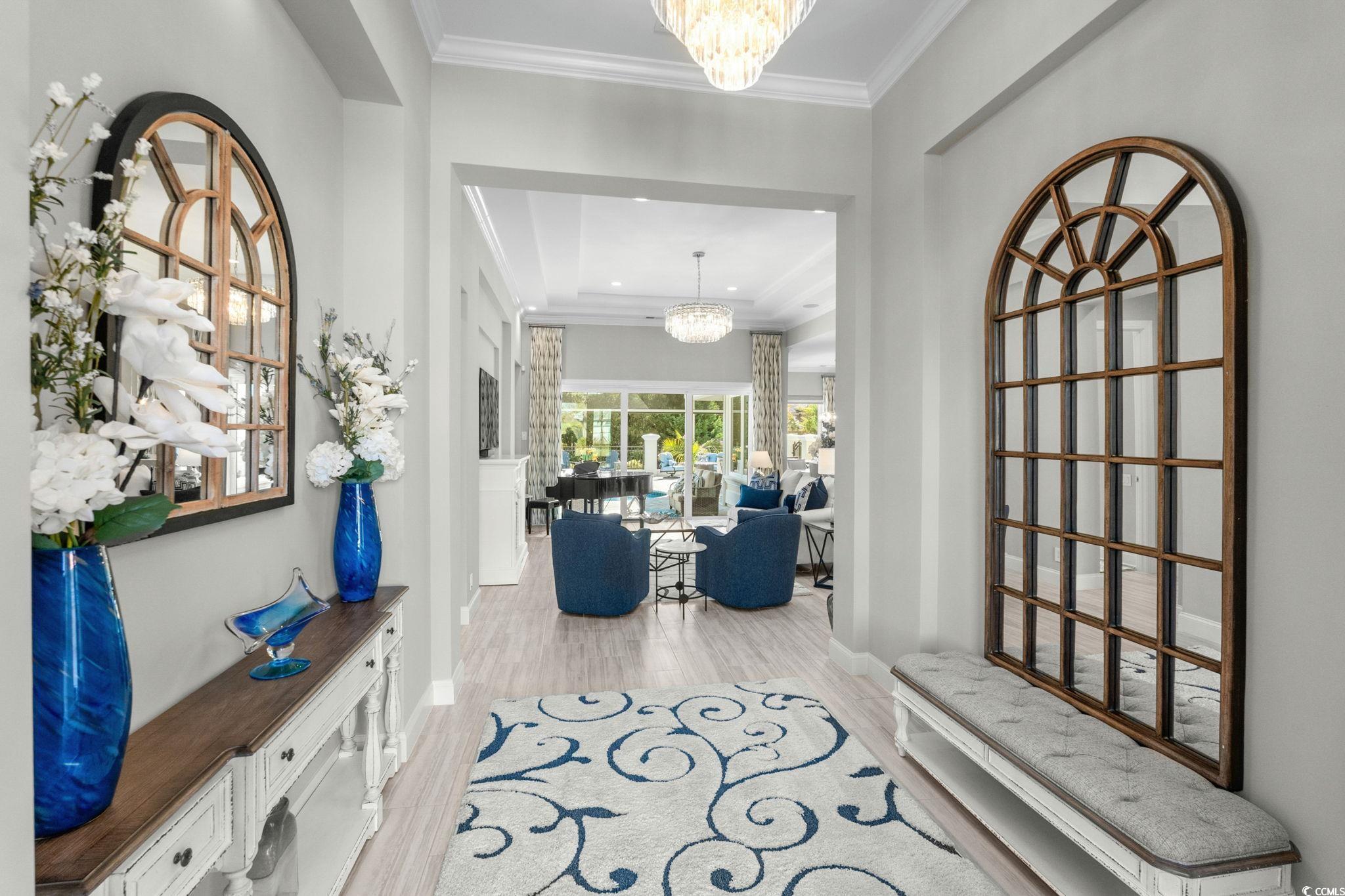 2225 Macerata Loop Myrtle Beach, SC 29579 - Photo 4 of 40 Foyer featuring a chandelier, light wood-style flooring, and crown molding