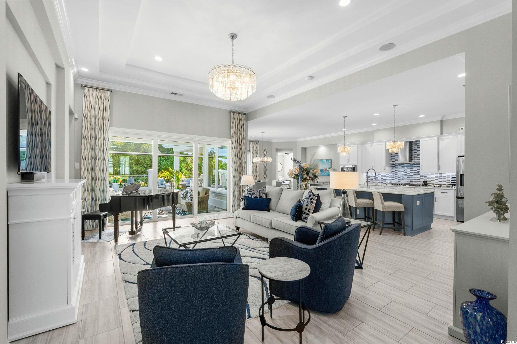 2225 Macerata Loop Myrtle Beach, SC 29579 - Photo 5 of 40 Living area with a chandelier, ornamental molding, recessed lighting, and a raised ceiling