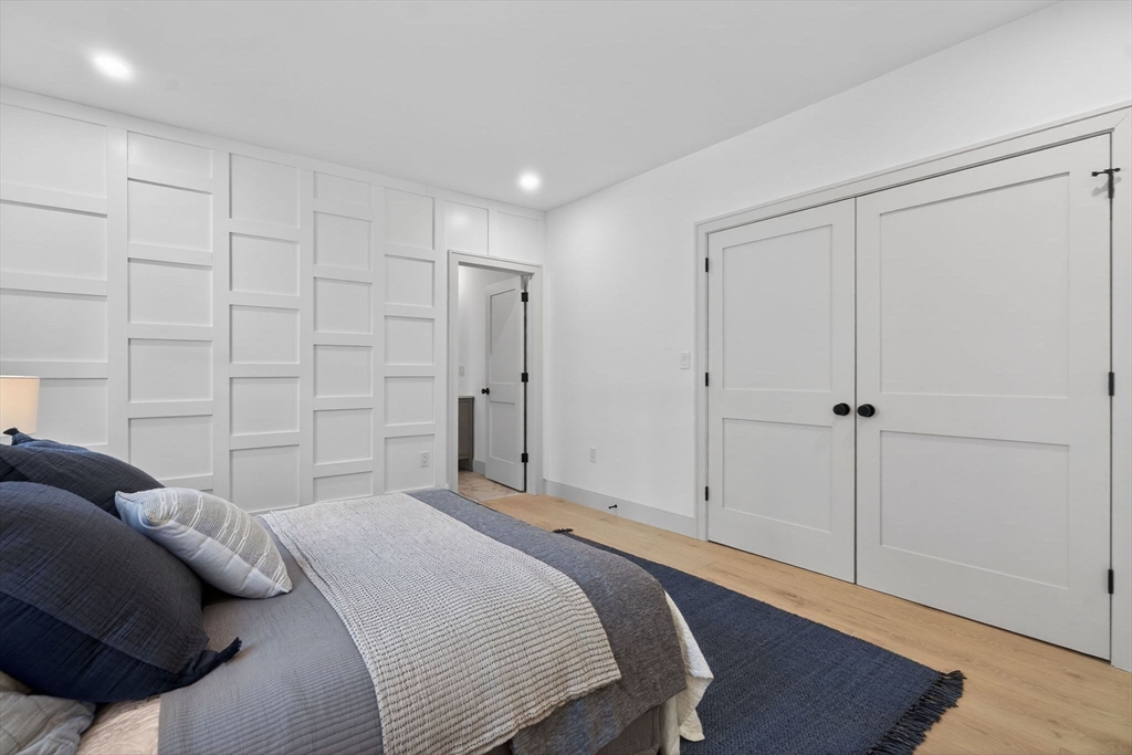 202 Powder House Boulevard, Unit 1 Somerville, MA 02144 - Photo 13 of 26 a bedroom with a bed and a closet