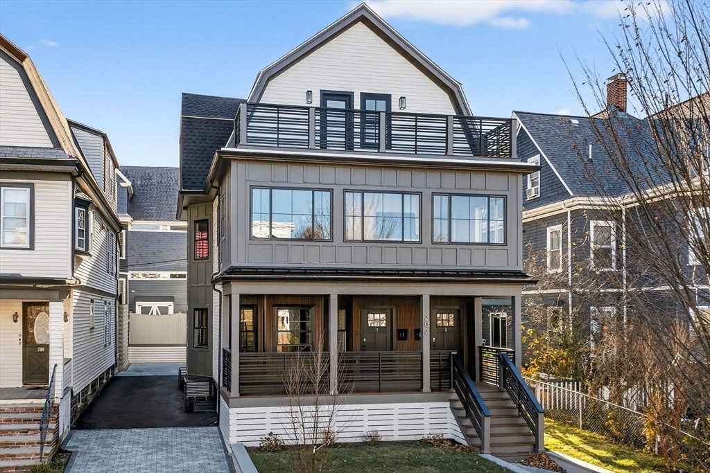 202 Powder House Boulevard, Unit 1 Somerville, MA 02144 - Photo 21 of 26 a front view of a house with glass windows