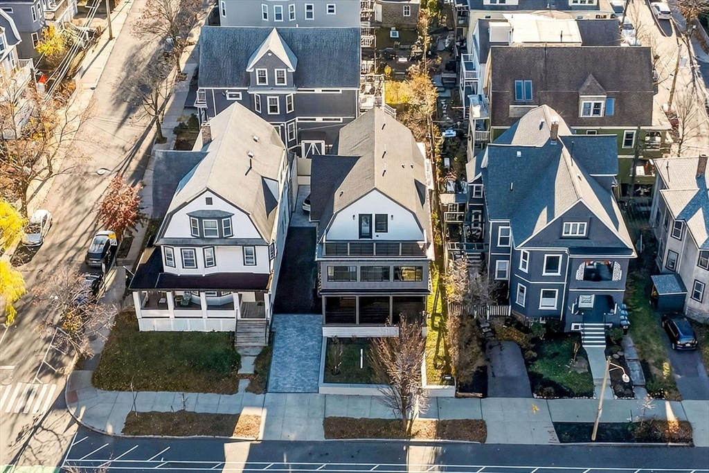 202 Powder House Boulevard, Unit 1 Somerville, MA 02144 - Photo 25 of 26 a view of building with lot of windows and yard