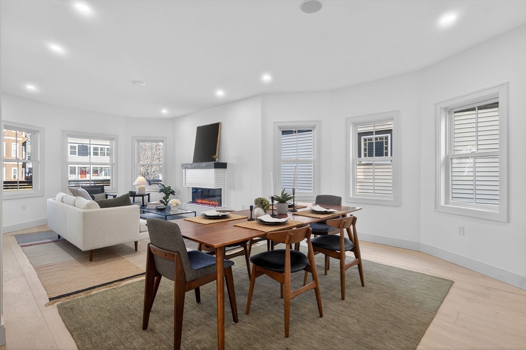 202 Powder House Boulevard, Unit 1 Somerville, MA 02144 - Photo 7 of 26 a view of a dining room with furniture and wooden floor
