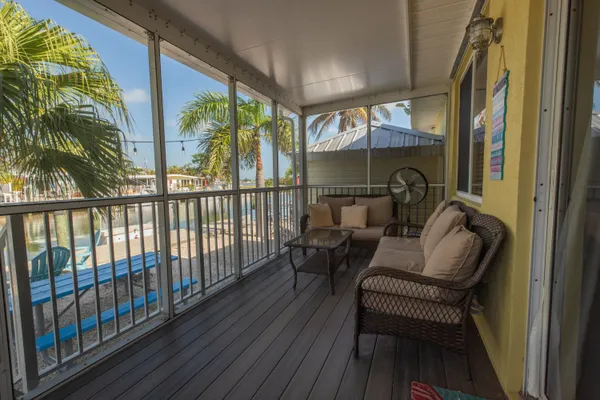 a balcony with furniture and a potted plant