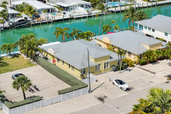 an aerial view of a house with outdoor space and lake view