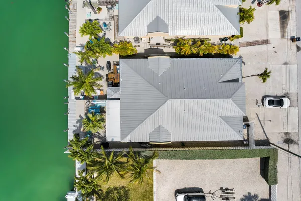 an aerial view of a house with a yard and seating area