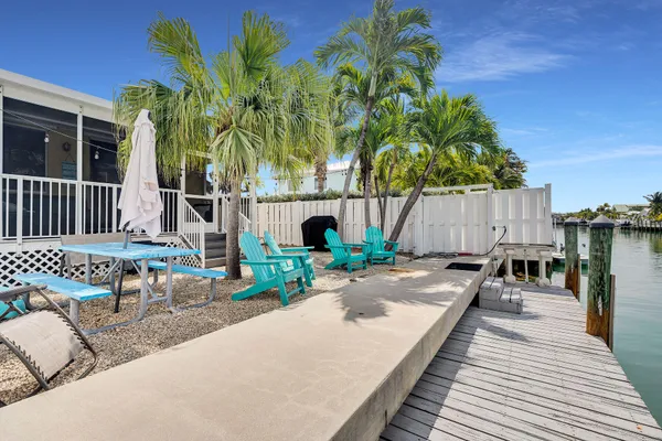 a swimming pool with outdoor seating and yard