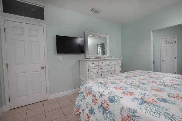 a bedroom with a bed and a flat screen tv