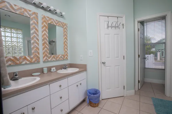 a spacious bathroom with a granite countertop sink and a mirror