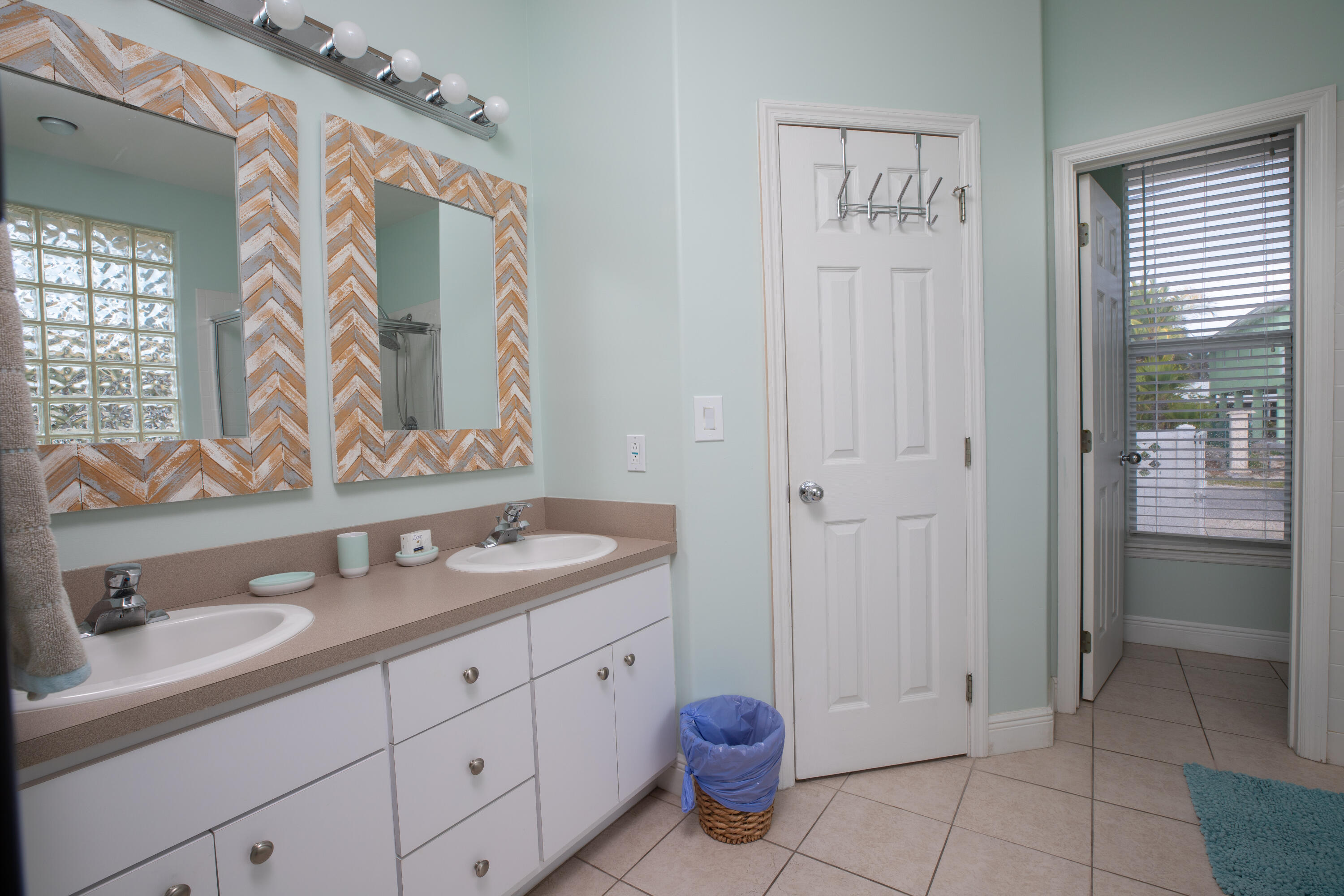 441 3rd Street Key Colony Beach, FL 33051 - Photo 8 of 29 a spacious bathroom with a granite countertop sink and a mirror
