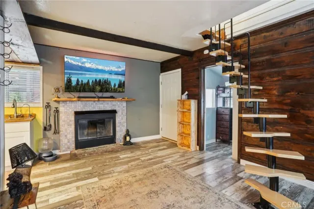 a view of an empty room with a fireplace and a window