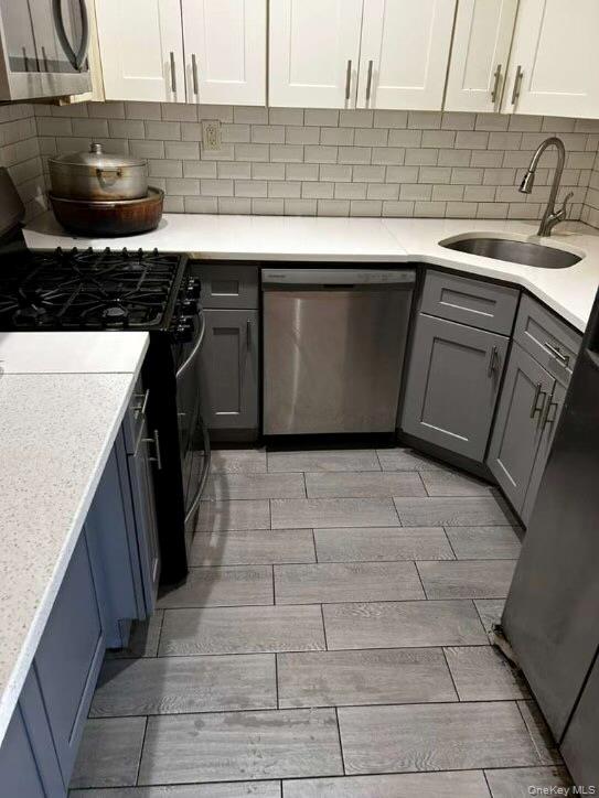 a kitchen with a sink a stove top oven and cabinets
