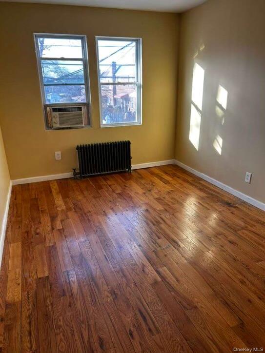 115-20 217th Street Queens, NY 11411 - Photo 4 of 8 an empty room with wooden floor and windows