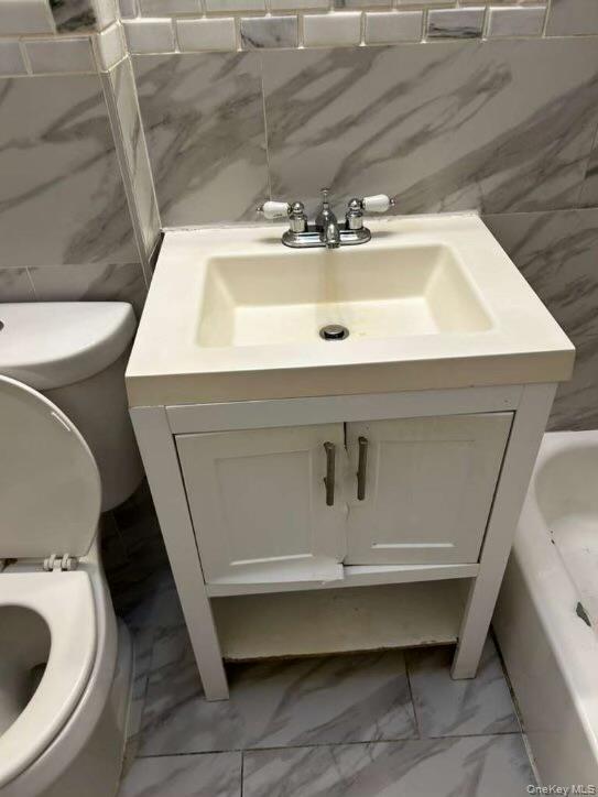 115-20 217th Street Queens, NY 11411 - Photo 6 of 8 a bathroom with a sink and toilet